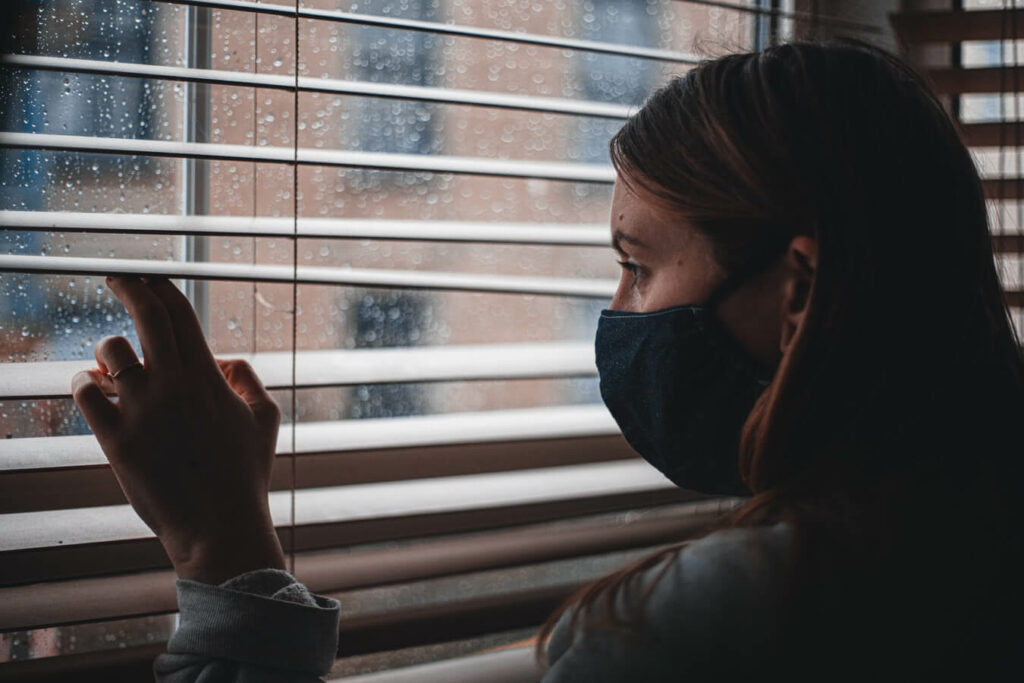 A person is looking at the stress behind the window and practice simple grounding techniques for anxiety relief